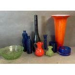 A selection of coloured and Studio glass to include jugs, bottles, and a vase