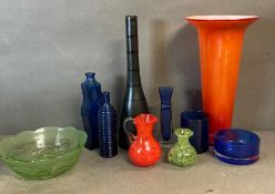 A selection of coloured and Studio glass to include jugs, bottles, and a vase