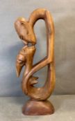 A wooden modern abstract sculpture of two people kissing (H59cm)