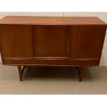 A Mid Century sideboard, three doors opening to shelves and drawers and three drawers to base on