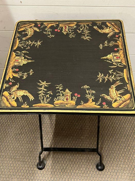 A metal folding table with decorated to table top