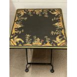 A metal folding table with decorated to table top