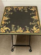 A metal folding table with decorated to table top