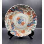 A single 19th Century Chinese Imari plate with scalloped edge and central Foo Dog decoration.