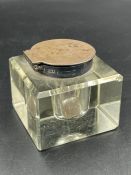 A hallmarked silver topped glass inkwell.