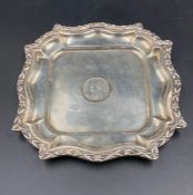 A silver tray, 15cm across, with inset Egyptian coin.
