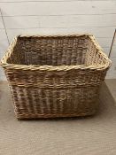 A large wicker laundry basket (H67cm W85cm D66cm)