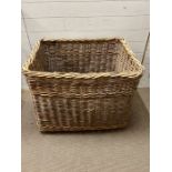 A large wicker laundry basket (H67cm W85cm D66cm)