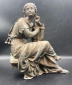 A cast metal classical figure of a lady playing a lyre. (Approximate 26cm H)