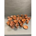 A selection of thirty terracotta garden plant pots, various sizes