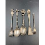 A small selection of four silver spoons and a fork.