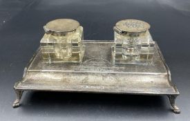 An engraved hallmarked silver desk set with glass and silver inkwells