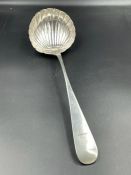 An 18th century silver ladle, with shell style bowl makers mark indistinct.