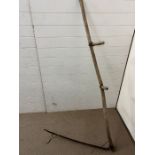 A vintage wooden handled scythe