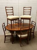 A McIntosh teak dining room table and six chairs (H77cm W150cm D95cm)