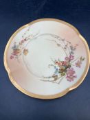 A Royal Worcester blush ivory side plate with floral decoration