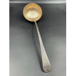 An 18th century silver ladle, with shell style bowl makers mark indistinct.