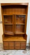 A side cabinet with glazed doors and panelled cupboard under by Nathan (H184cm W102cm D45cm)