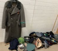 A large selection of reproduction military items including German border coat and USSR caps and hats