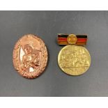Two East German military medals.