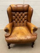 A leather Chesterfield button back wing chair
