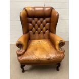 A leather Chesterfield button back wing chair