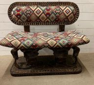 A South African carved bench seat with a kilim style, upholstered and carved birds to back and base