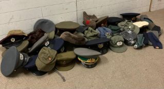 A selection of reproduction military hats and caps