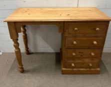 A pine dressing table with drawers to right and turned legs (H76cm W107cm D48cm)
