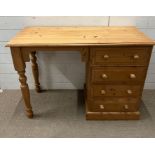 A pine dressing table with drawers to right and turned legs (H76cm W107cm D48cm)