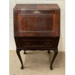 A slim mahogany bureau