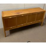 A Mid Century sideboard with four doors to front and drawers under (H86cm W175cm D45cm)