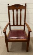 An Arts and Crafts oak arm chair