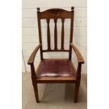 An Arts and Crafts oak arm chair