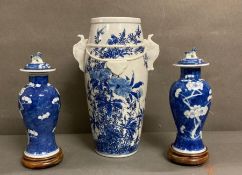 Three blue and white Chinese vases with floral design, two with Foo dog detail to tops