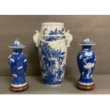 Three blue and white Chinese vases with floral design, two with Foo dog detail to tops