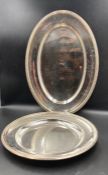 Two Cristofle trays one oval (Approx 45cm in length) one circular (Approx 33cm in diameter)