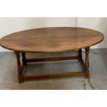 An oval coffee table (H47cm W122cm D63cm)