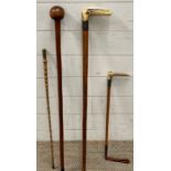 Four hunting and walking sticks, two with silver collars and one with a military crest