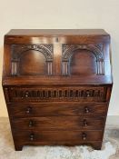 An oak bureau with fall front opening drawers pigeon holes (H97cm W77cm D45cm)