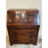 An oak bureau with fall front opening drawers pigeon holes (H97cm W77cm D45cm)