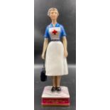 A Royal Worcester figure, British Red Cross Society VAD member, modelled by R van Ruyckevelt, 1969