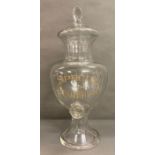 A large glass special Irish whisky dispenser/decanter with faceted lid on a flared circular foot (