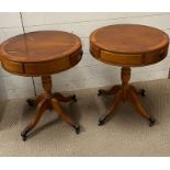 A pair of drum tables with down swept legs and lion paw feet on castors (H59cm Dia49cm)