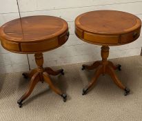 A pair of drum tables with down swept legs and lion paw feet on castors (H59cm Dia49cm)