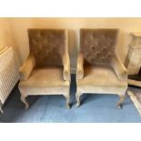 A pair of button back arm chairs on cabriole legs