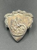 A Wilson and Sharp silver badge, hallmarked for Edinburgh, featuring George and the Dragon.