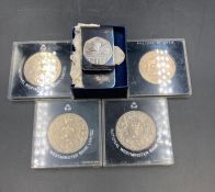 Coin Collectors: Three 1997 crowns and 1974 Liberty dollar and a Royal Mint money clip with a 2000