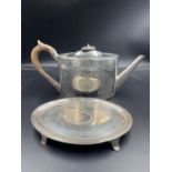 A hallmarked Georgian teapot and stand with matching armorial.