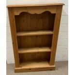 A pine shelving unit with scrolling top (H104cm W68cm D22cm)